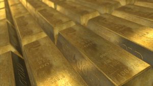 Pile of gold bars stacked in a vault, polished and shiny.